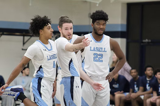 Junior guard Conan McCusker talks with first-year guards Che Hanks and Cameron Foster-Martez during a home win against Husson in December.