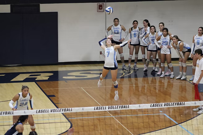 Junior setter Sydney Katz serves to the St. Joseph's.
