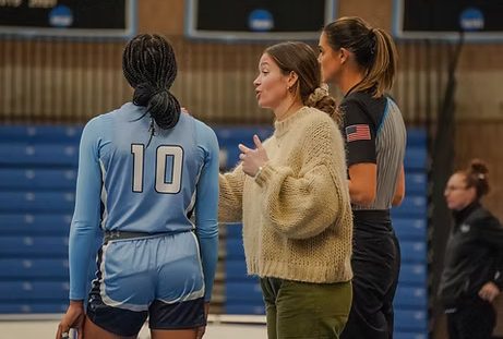 Lasell women's basketball coach Kelley Sundberg (center) in action next to sophomore forward Laura Johnson.