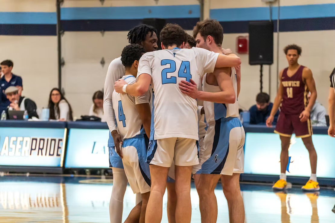 The Lasers huddle on the court during their playoff game vs. Norwich.