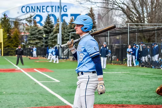 Senior captain Bryan Baumann at the plate on a road trip against Suffolk College. 