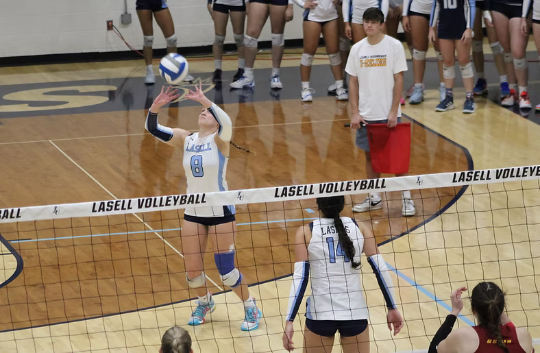 McKenna McCool setting the ball versus Regis.