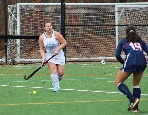 Lily Reidy carries the ball vs. New England College at Grellier Field. (Photo courtesy of Lasell Athletics)