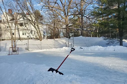The Seminary Avenue ice rink, freshly shoveled and adorned with hockey goals and sticks for student use.