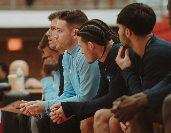 Conan McCusker (middle) joins the Lasell basketball coaching staff after a four-year stint as a guard for the Lasers. (Photo courtesy of Luisne McCusker)