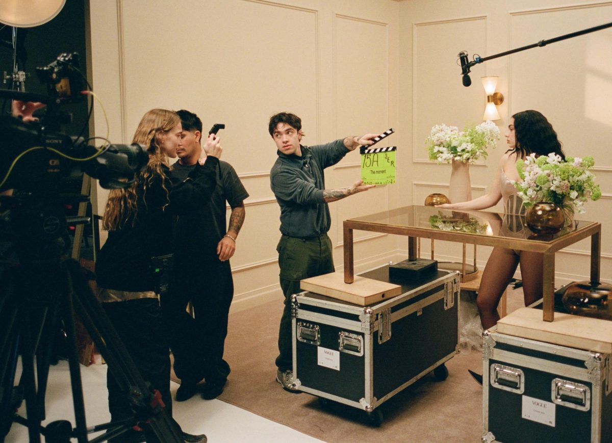 Aidan Zamiri (with slate) and Charli XCX (right) on the set of "The Moment." (Photo courtesy of Henry Redcliffe)