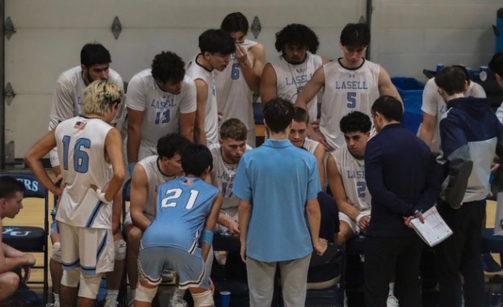 The Lasell men’s volleyball team huddles to discuss the game plan during timeout in the Athletic Center. (Photo courtesy of Lasell Athletics)