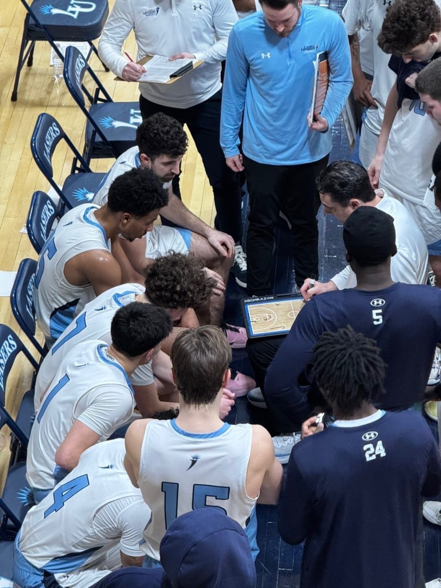 Basketball team huddles and disccuses game plan during a timeout. (Photo courtesy of Joseph Gattuso)