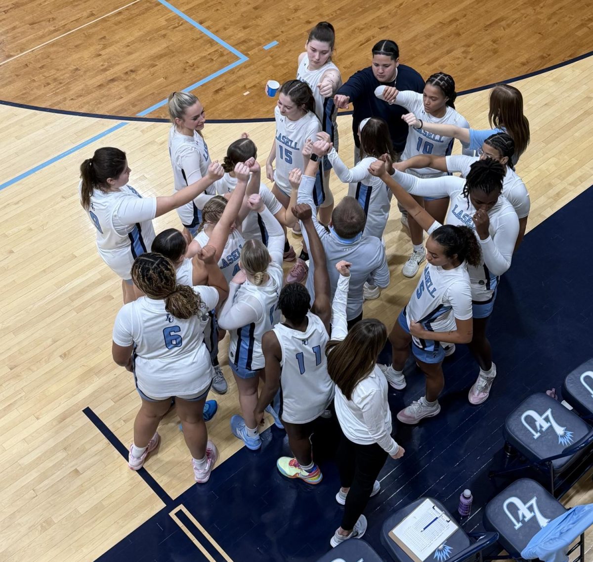 Women’s basketball team huddles during a timeout against Worcester State University on Nov. 14. (Photo courtesy of Leila Kollmorgan)