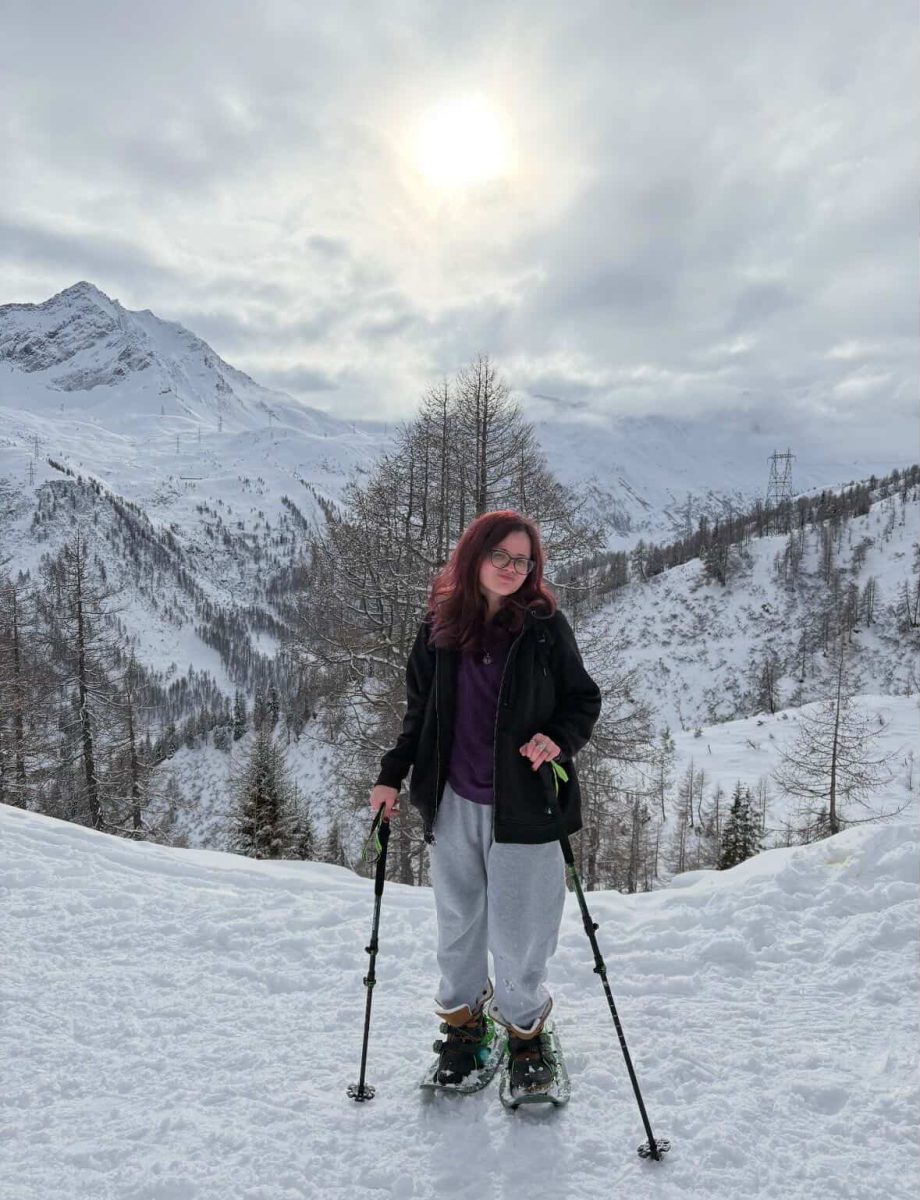 Gianna Lipka poses on skis in the mountains of the Swiss Alps.