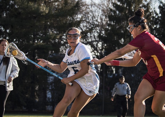 Freshman attacker Juliana Gonzalez on the move against Regis College on March 25. (Photo courtesy of Lasell Athletics)