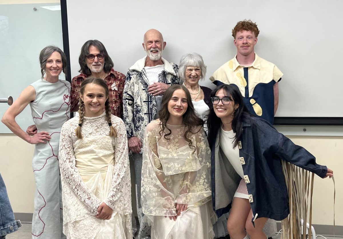Madilyn Ebbinghaus (bottom center) poses with her models for her senior collection, “What Finds Its Way Home.” (Photo courtesy of Madilyn Ebbinghaus)