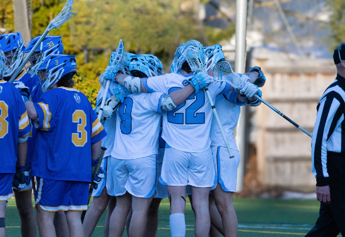 Sophomore midfielder Nick Halesworth (L) huddles up with senior midfielder Nate Campbell and others midgame. (Photo courtesy of Sophia Goldin)